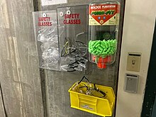 A PPE station, containing eye protection and earplugs, as well as a place to dispose of dirty glasses. SafetyGlassesAndEarplugs.jpg