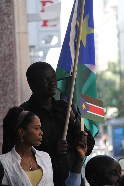 File:South Sudanese watch flag raising on independence day (5926601217).jpg