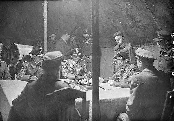 British Field-Marshal Bernard Montgomery (seated second from the right) signs the terms of the surrender watched by Rear Admiral Wagner and Admiral vo