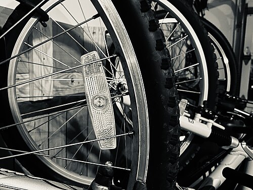 Bicycles stored on garage wall.