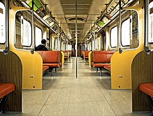 Interior of an H-4 subway car. The H-4s had an interior design similar to that of the H-2 subway cars but had less seating to allow for more passengers. The H-4s were the last H-series cars to have large padded bench seats. The H-2 and H-4 cars had beige doors, yellow panels, orange padded seats, dark brown walls and light brown floors. These were the last Toronto subway car models not equipped with air-conditioning systems. Toronto Subway Train Type H-4 Interior.jpg