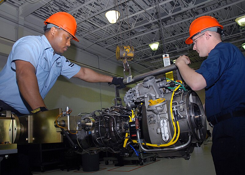 File:US Navy 070402-N-1550W-003 Aviation Machinist's Mate 2nd Class James Roberts and Aviation Machinist's Mate Airman Michael Brinkman of Aviation Support Detachment Mayport remove a T-700 engine frame from a maintenance stand for.jpg