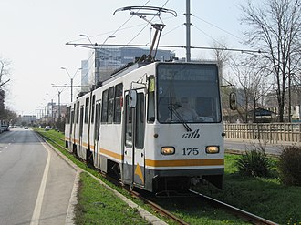 A V3A tram running down tracks embedded in grass on the Timisoara Boulevard in Bucharest, Romania V3A 175 on Timisoara Boulevard.jpg