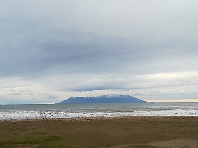 View of snowy Samothrace from a beach in Alexandroupolis