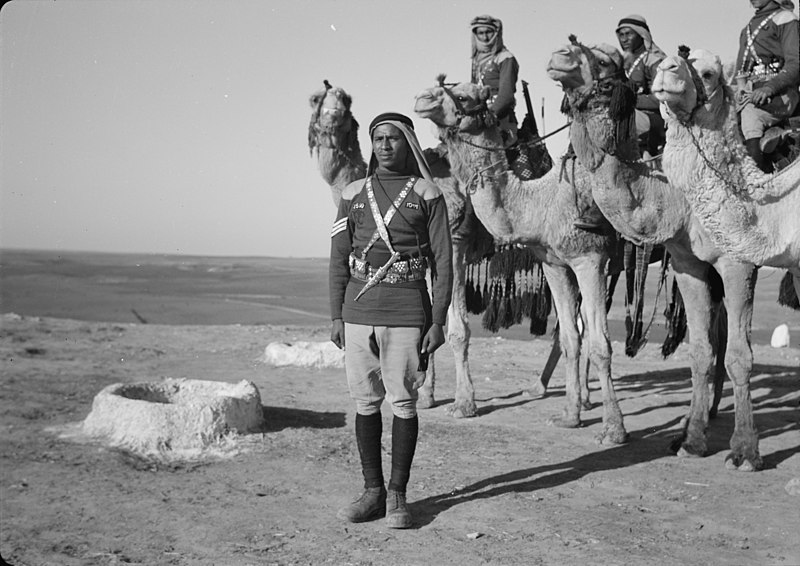 File:A tribal lunch at cavalry post at Tel-el-Meleiha, 20 miles North of Beersheba, Jan. 18, 1940. Camelmen on top of Tel LOC matpc.19973.jpg