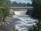 A flowing river with a small waterfall at the end