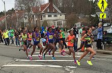 Lead group of nine women at mile 19, with Caroline Rotich on left Boston 2015 lead women.cropped.jpg
