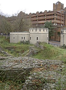 Remains of Bristol Castle in 2011, with crenelated public convenience and Newgate Street beyond, looking north-west BristolCastleRuins And CrenellatedPublicConvenience.jpg