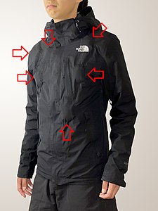 The first stunt jacket with 6x bullet hit squibs (labelled) embedded. This example shows the amount of bulge beneath a thick and dark-coloured outfit. Each squib contains 25 g of fake blood.