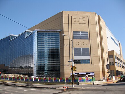 The western facade of the arena in March 2010 before it officially opened and its arena signage installed, with the Civic Arena reflected in its curtain wall window.
