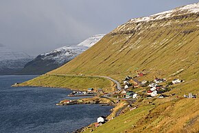 The village of Skipanes on Eysturoy, with different weather in the distance Faroe Islands, Eysturoy, Skipanes and Undir Gotueidi.jpg