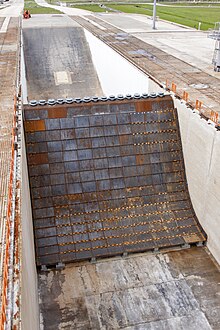 The main flame deflector in the flame trench at Launch Complex 39B at NASA's Kennedy Space Center in Florida. It deflects the plume exhaust from NASA's Space Launch System rocket during launch. It features a new "steel plated" design and incorporates water pipes for sound suppression. Flame Deflector Complete at Launch Complex 39B (KSC-20180516-PH KLS01 0007).jpg