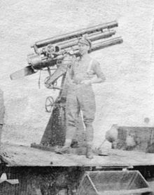Gunner of 99th Anti-aircraft Section at Salonika, with gun mounted on a Thornycroft lorry. Gunnner with QF 13 pounder Mk IV AA gun Salonika WWI.jpg