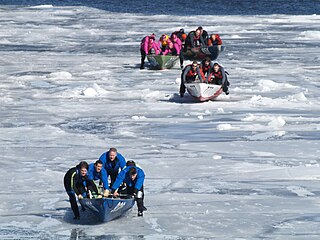 Ice canoeing Boat race combining rowing and dragging over ice