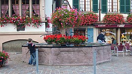 Kintzheim: In earlier centuries the village fountain would have been a meeting point for villagers, but during the twentieth century the arrival of a piped water supply left the fountain playing a largely decorative role. Kintzheim 062.JPG