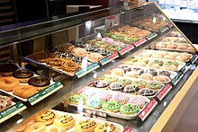 An assortment of doughnuts on display in a shop in Tachikawa, Tokyo Krispy Kreme Doughnuts by Japan Line-Up (Tachikawa LUMINE Shop).jpg