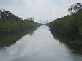 View of the Canal from the Mirabeau Bridge looking River wards; skyscrapers of New Orleans Central Business District visible in distance.