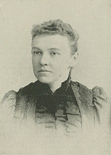 B&W portrait photo of a woman with her hair in an up-do.