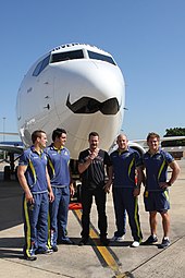 Members of the Australia national rugby union team at the unveiling of a promotionally decorated Boeing 737-800 aircraft, during Movember in 2011 Movember (8140156949).jpg