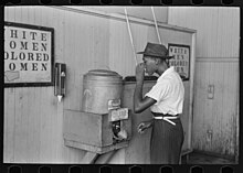 Negro drinking at "Colored" water cooler in streetcar terminal, Oklahoma City, Oklahoma Negro drinking at "Colored" water cooler in streetcar terminal, Oklahoma City, Oklahoma LOC 15359682455.jpg