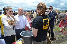 Foreign Secretary William Hague and UNHCR Special Envoy Angelina Jolie at Nzolo displacement camp, near Goma, eastern Democratic Republic of Congo, 25 March 2013, meeting refugees and the International Rescue Committee Nzolo displacement camp (8595014596).jpg