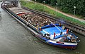 A self propelled barge carrying recycling material on Deûle channel in Lambersart, France