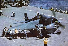 F6F-3 aboard USS Yorktown has its Sto-Wing folding wings deployed for takeoff (circa 1943-44)