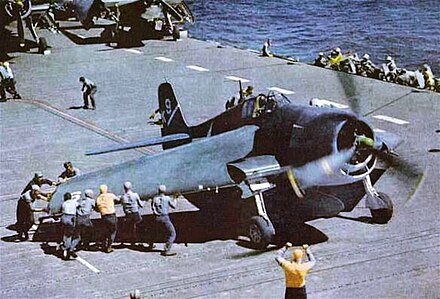 F6F-3 aboard USS Yorktown has its "Sto-Wing" folding wings deployed for takeoff (circa 1943-44)