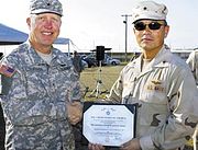 Rear Admiral Harry Harris gives Defense Superior Service Medal to Brigadier General Edward Leacock