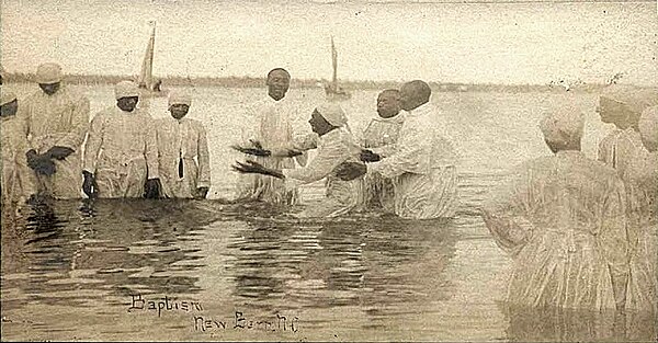 "Wade in the water." A postcard of a river baptism in New Bern, North Carolina, around 1900.