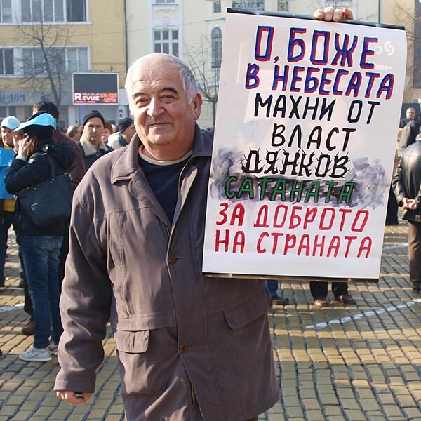 A Bulgarian citizen on strike in February 2013 holding a sign "Simeon Djankov is Satan"