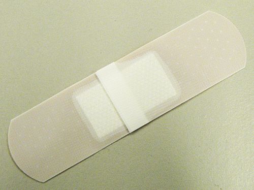 Reverse of an adhesive bandage, showing backing