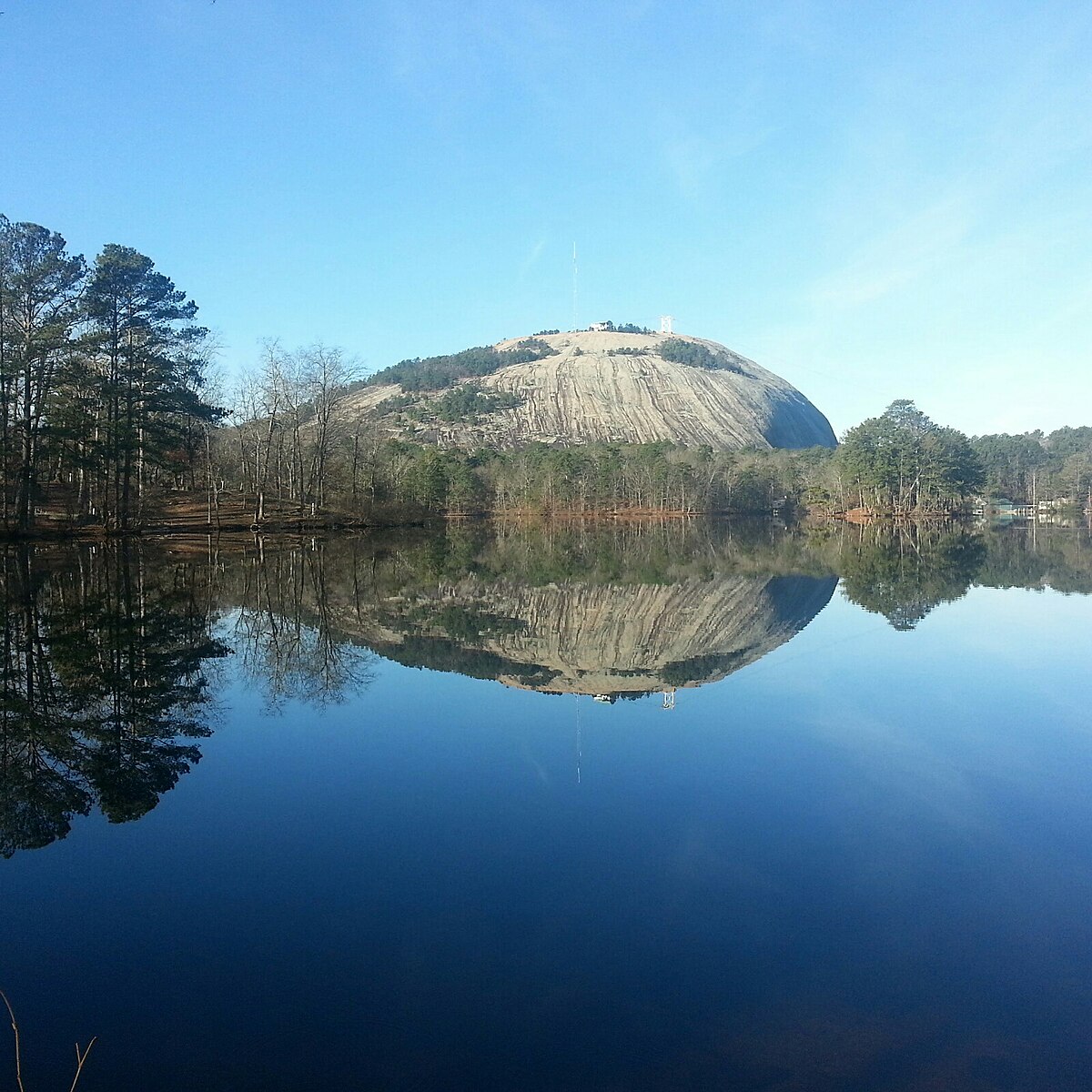 To measure a stone face carved on the side of a mountain, two