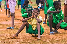 A child who is tired during free play will sit down to rest. During adult-directed sports activities, the child's need for rest may not be respected. Tired after play.jpg