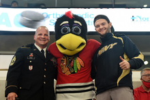 Tommy Hawk poses with servicemen in October 2021. Tommyhawk-mascot-2021.webp