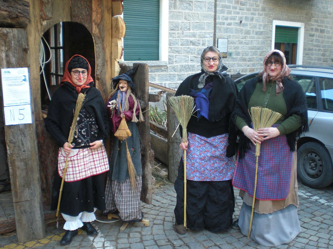 Three women dress up as La Befana. 