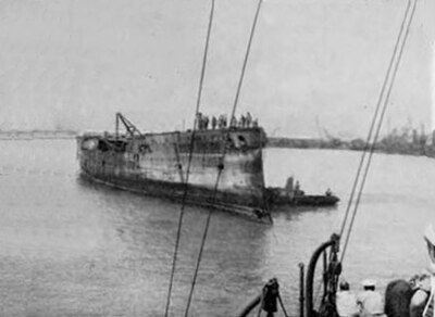 USS Baltimore in partially salvaged condition being examined by Seabees of the 133rd Naval Construction Battalion at Naval Station Pearl Harbor