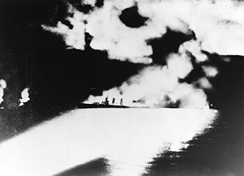 USS Quincy (CA-39) under fire during the Battle of Savo Island on 9 August 1942 (NH 50346).jpg