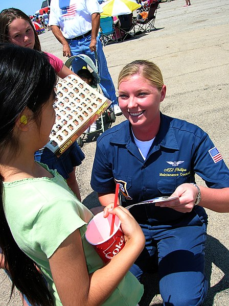 File:US Navy 060514-N-8374E-002 Aviation Maintenance Administrationman 2nd Class Desiree Phillips, assigned to Maintenance Control on the Blue Angels enlisted team, autographs memorabilia for enthusiastic young fans.jpg