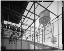VIEW OF WATER TOWER FROM ELECTRICAL TRANSFORMER CAGE AT NORTH END OF SECOND FLOOR WAREHOUSE. VIEW TO WEST-NORTHWEST. - Ford Motor Company Long Beach Assembly Plant, Assembly HAER CAL,19-LONGB,2-A-4.tif