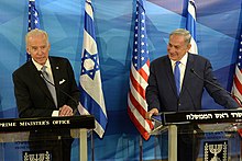 Photo of Biden and Netanyahu giving speeches, with American and Israeli flags in the background