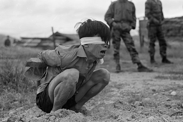 A Viet Cong prisoner captured in 1967 by the U.S. Army awaits interrogation.