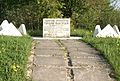 A memorial stone of the Vyshgorodok hillfort that reads "An archeological monument - Vyshgorodok hillfort. Founded in 1476. During the XV-XVI centuries it was one of the fortification on the westernmost frontier of the Pskovian Land. Preserved by the Government."