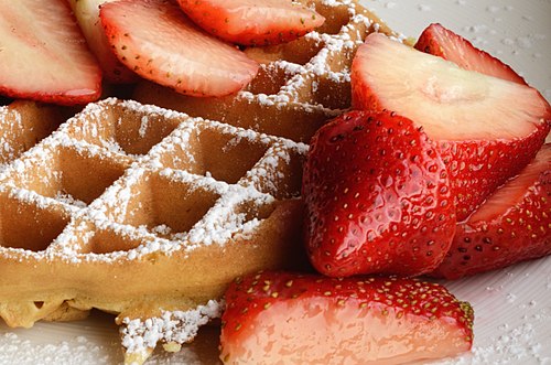 Waffle with strawberries and confectioner