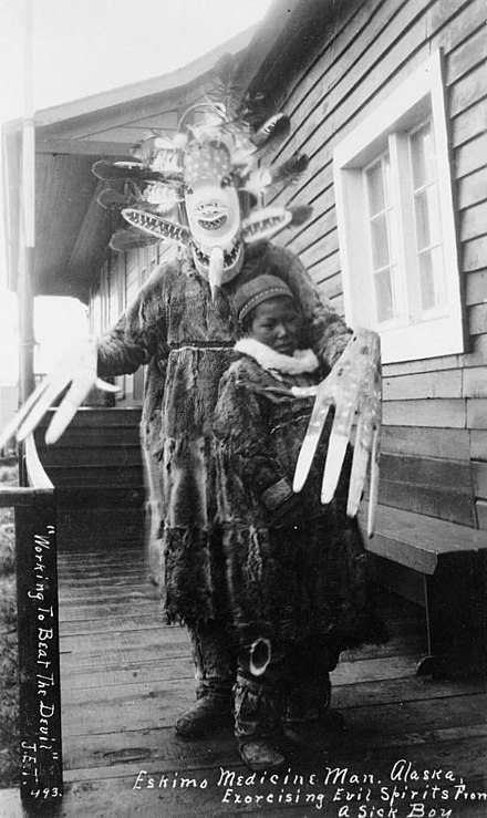 Yup'ik "medicine man exorcising evil spirits from a sick boy" in Nushagak, Alaska, 1890s[1]