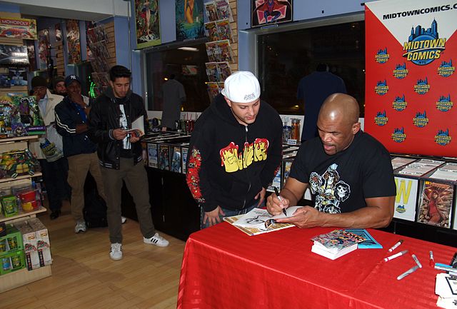 McDaniels signs copies of his comic book, DMC #1, at a November 6, 2014 appearance at Midtown Comics in Manhattan.