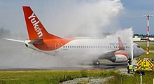 An Air North flight receives a water-cannon salute after completing the airline's first scheduled flight to Victoria from Whitehorse, May 2018. Air North YYJ Inagural Flight.jpg