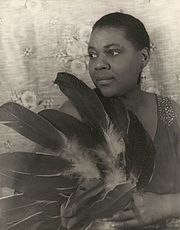 Bessie Smith, an early blues singer, known for her powerful voice Bessie Smith (1936) by Carl Van Vechten.jpg