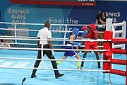 Deutsch: Boxen bei den Olympischen Jugendspielen 2018 Tag 12, 18. Oktober 2018 - Finale Fliegengewicht Mädchen – Martina La Piana (Italien, blau) schlägt Adijat Gbadamosi (Nigeria, rot) 5-0; Ringrichter ist James Beckles (Trinidad und Tobago). English: Boxing at the 2018 Summer Youth Olympics on 18 October 2018 – Girl's flyweight Gold Medal Bout - Martina La Piana (Italy, blue) beats Adijat Gbadamosi (Nigeria, red) 5-0; Referee is James Beckles (Trinidad and Tobago). Español: Boxeo en los Juegos Olímpicos Juveniles de Verano de 2018 en 18 de octubre de 2018 - Combate a medalla de oro de peso mosca para mujeres: Martina La Piana (Italia, azul) le gana a Adijat Gbadamosi (Nigeria, roja) 5-0; El árbitro es James Beckles (Trinidad y Tobago).