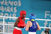 Deutsch: Boxen bei den Olympischen Jugendspielen 2018 Tag 12, 18. Oktober 2018 - Finale Fliegengewicht Mädchen – Martina La Piana (Italien, blau) schlägt Adijat Gbadamosi (Nigeria, rot) 5-0; Ringrichter ist James Beckles (Trinidad und Tobago). English: Boxing at the 2018 Summer Youth Olympics on 18 October 2018 – Girl's flyweight Gold Medal Bout - Martina La Piana (Italy, blue) beats Adijat Gbadamosi (Nigeria, red) 5-0; Referee is James Beckles (Trinidad and Tobago). Español: Boxeo en los Juegos Olímpicos Juveniles de Verano de 2018 en 18 de octubre de 2018 - Combate a medalla de oro de peso mosca para mujeres: Martina La Piana (Italia, azul) le gana a Adijat Gbadamosi (Nigeria, roja) 5-0; El árbitro es James Beckles (Trinidad y Tobago).